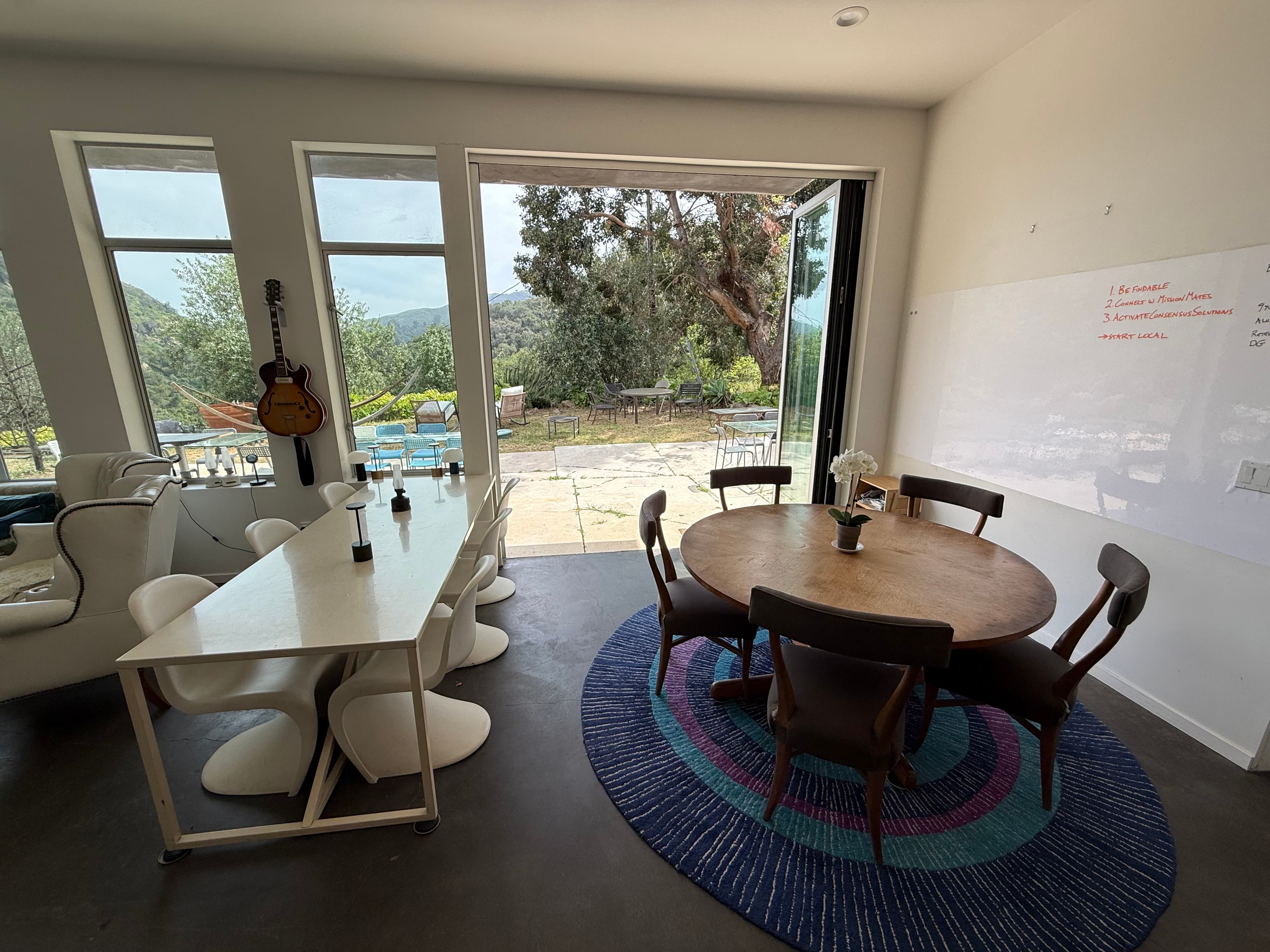 Shared cowork tables open during the day inside the house.