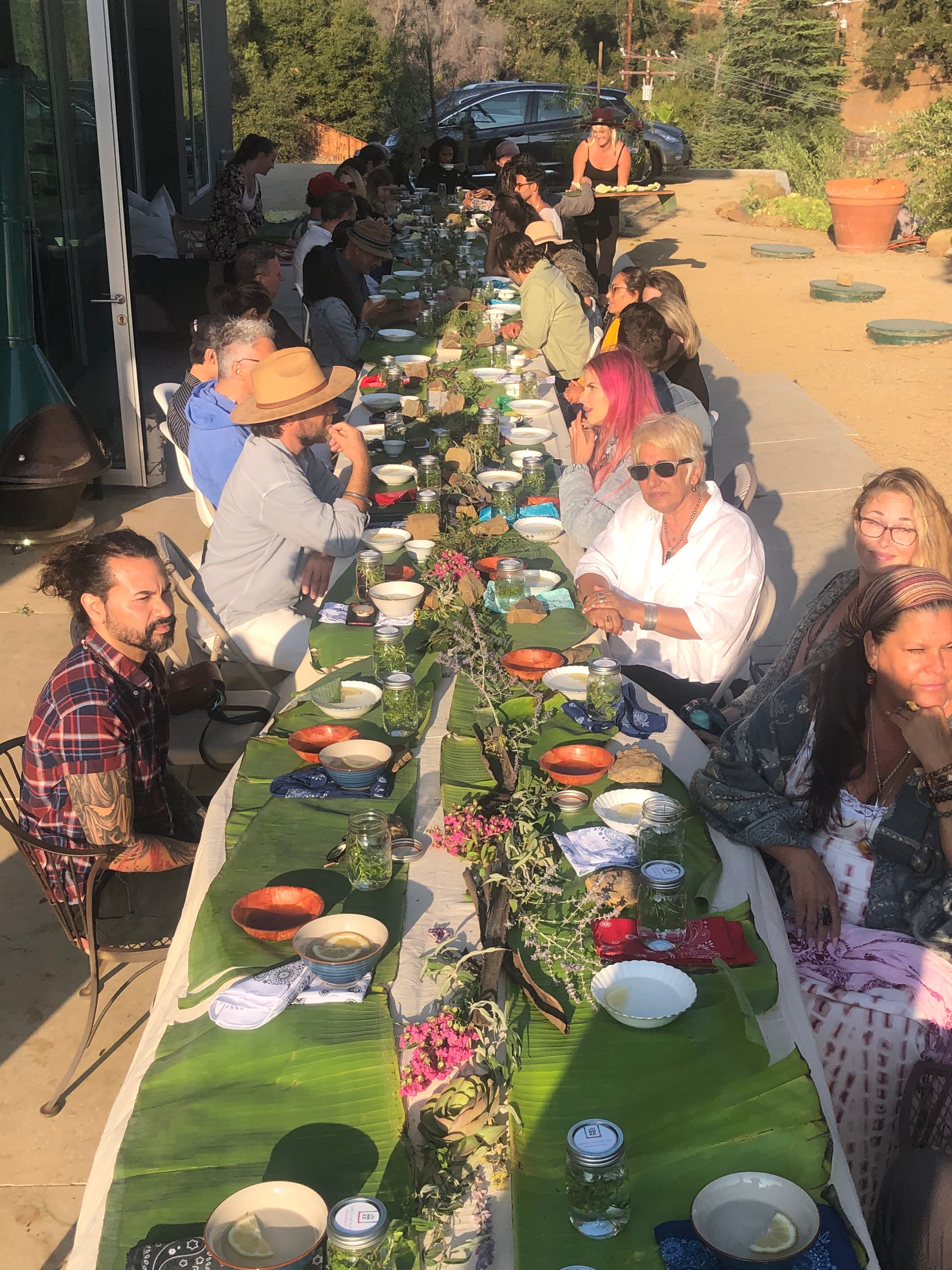 Long outdoor table set for a Friendsgiving gathering.