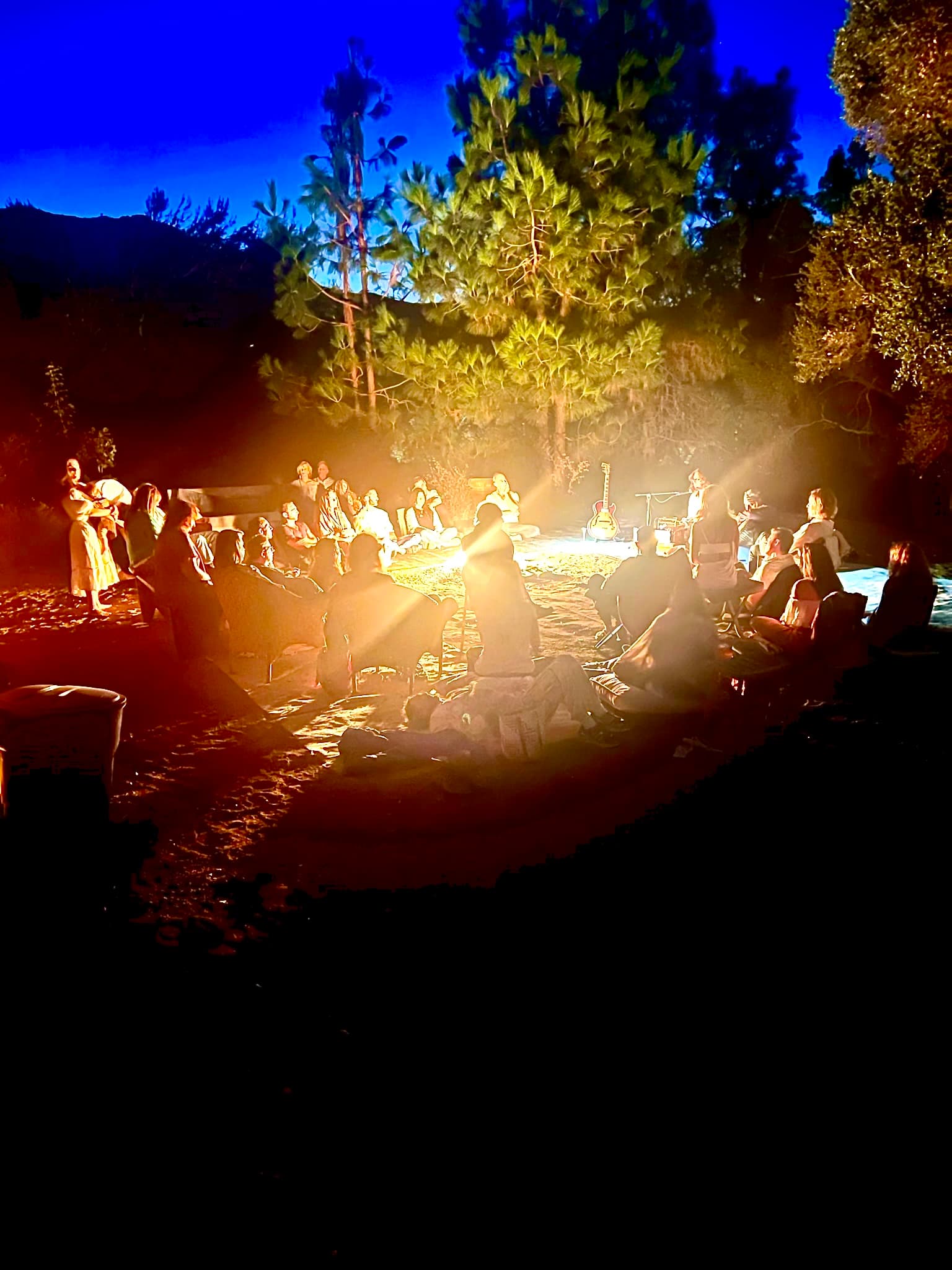 Nighttime fire circle gathering at the house.